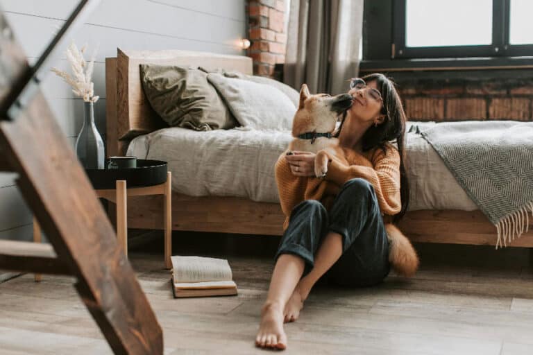 An image of a dog and a woman cuddling, after successful Jacksonville dog training