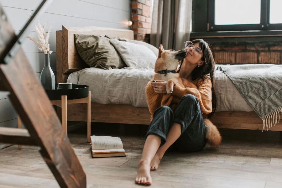 An image of a dog and a woman cuddling, after successful Jacksonville dog training
